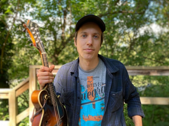 Brett Kretzer holding a mandolin