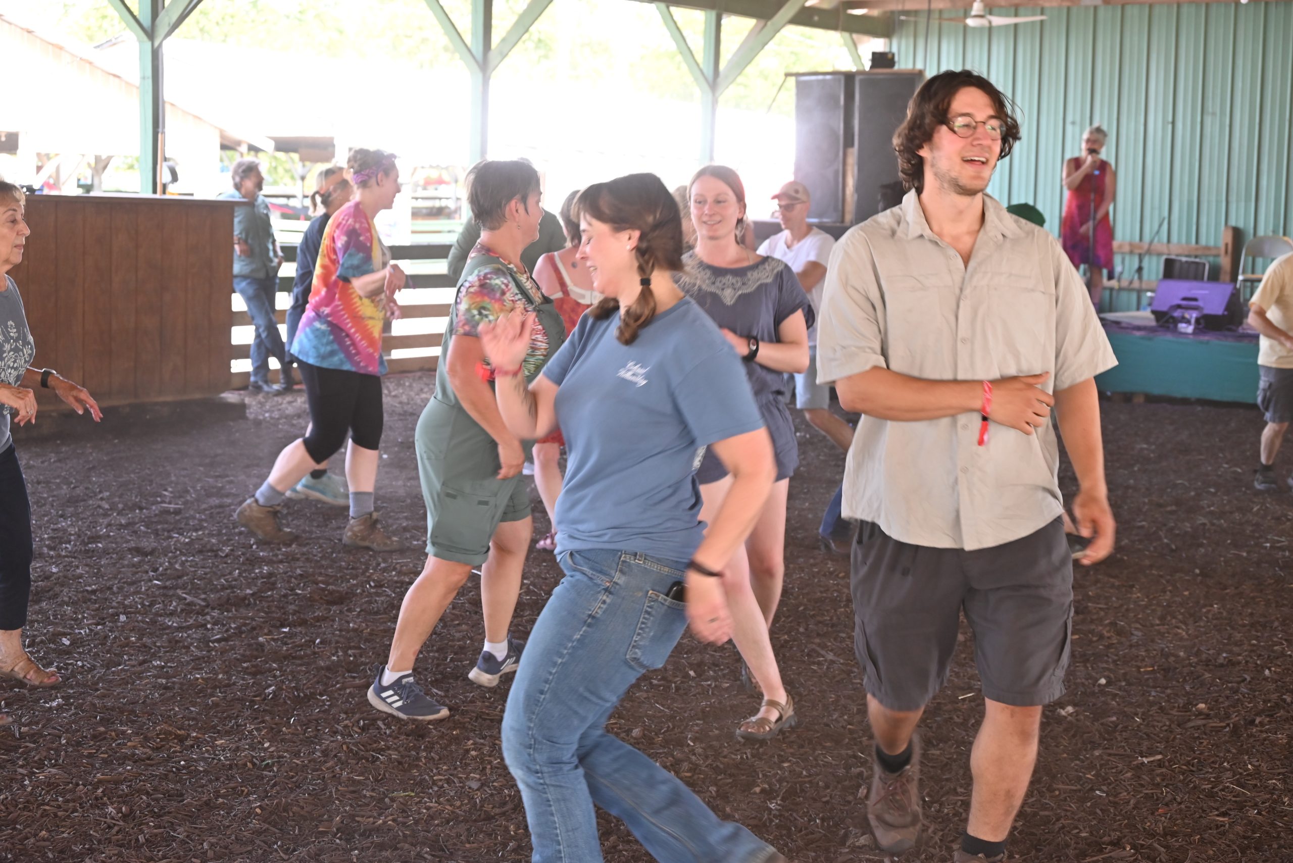 Happy people square dancing in the dance barn at Watermelon Pickers' Fest.