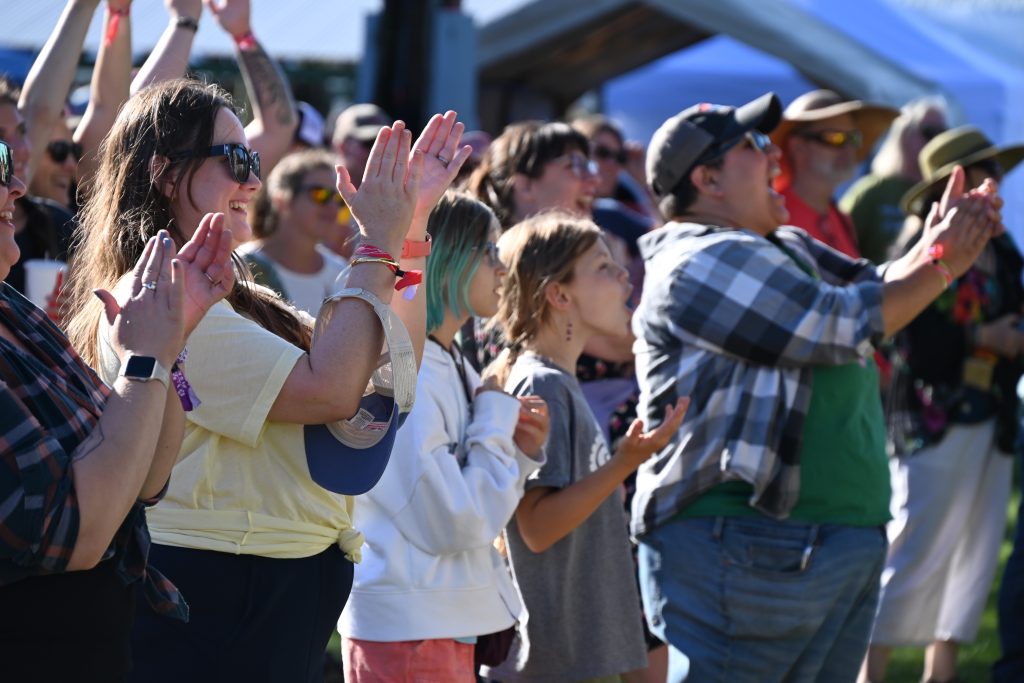 A happy crowd cheers while watching the main stage show at the Watermelon Pickers' Fest