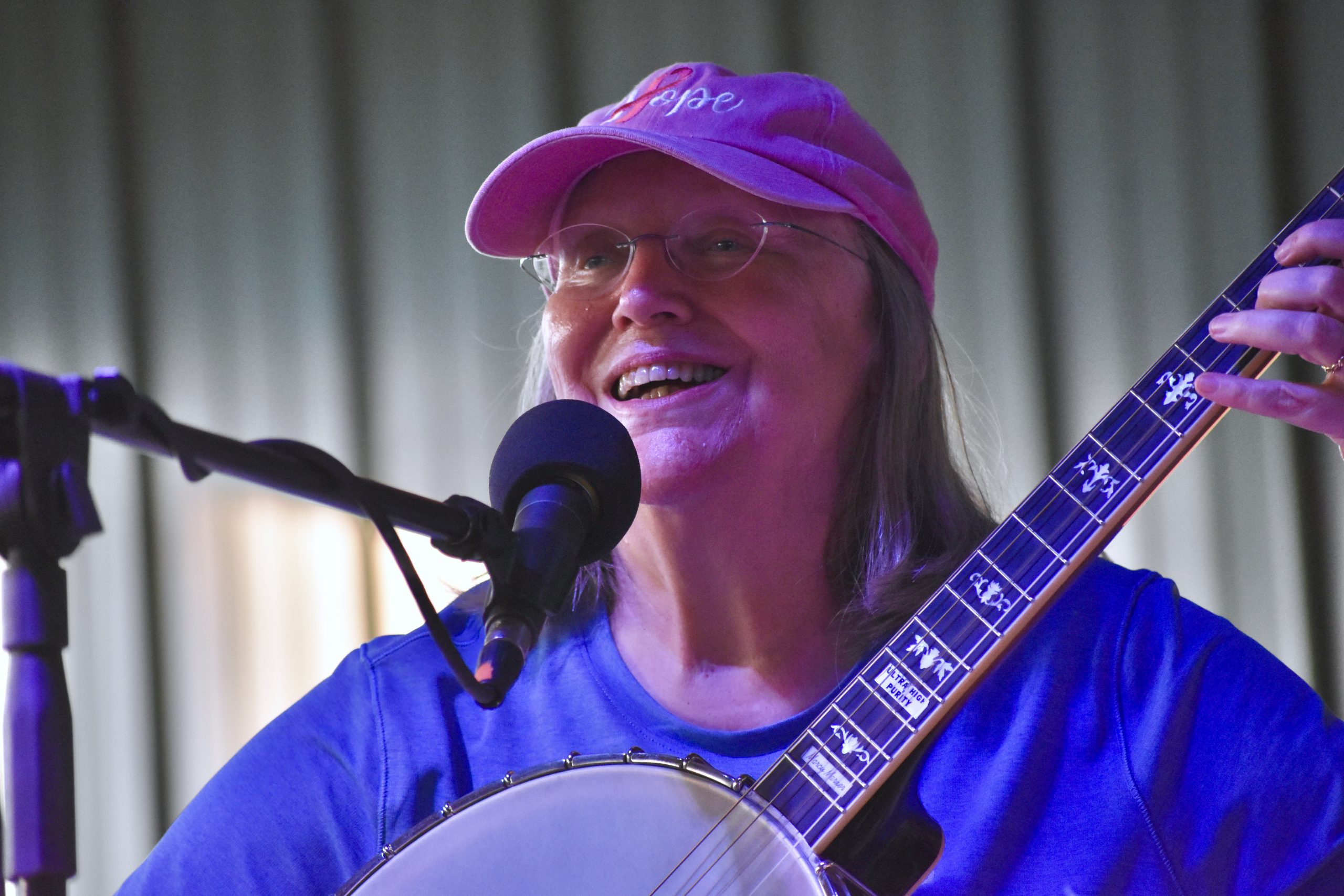 Marcy Marxer – photo by Kevin Slick Smiling close-up of Marcy Marxer performing at the 2025 Watermelon Pickers' Fest.