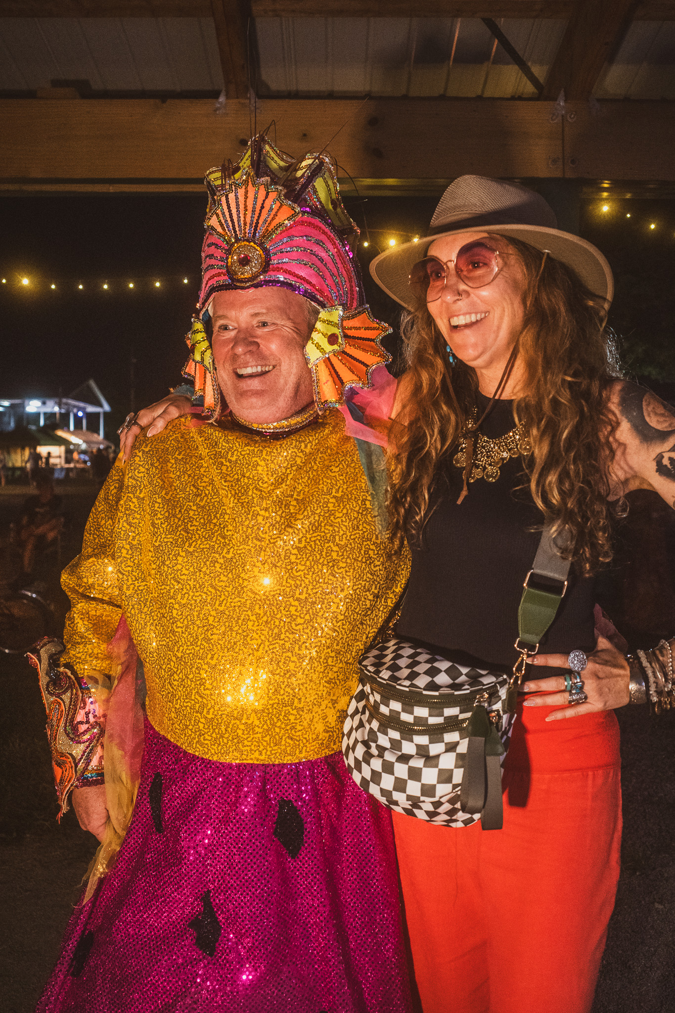 Princess Watermelon and Friend – photo by John Cromartie Neil is smiling, dressed in his Watermelon Princess costume, standing with a happy woman at the Neurology Tent